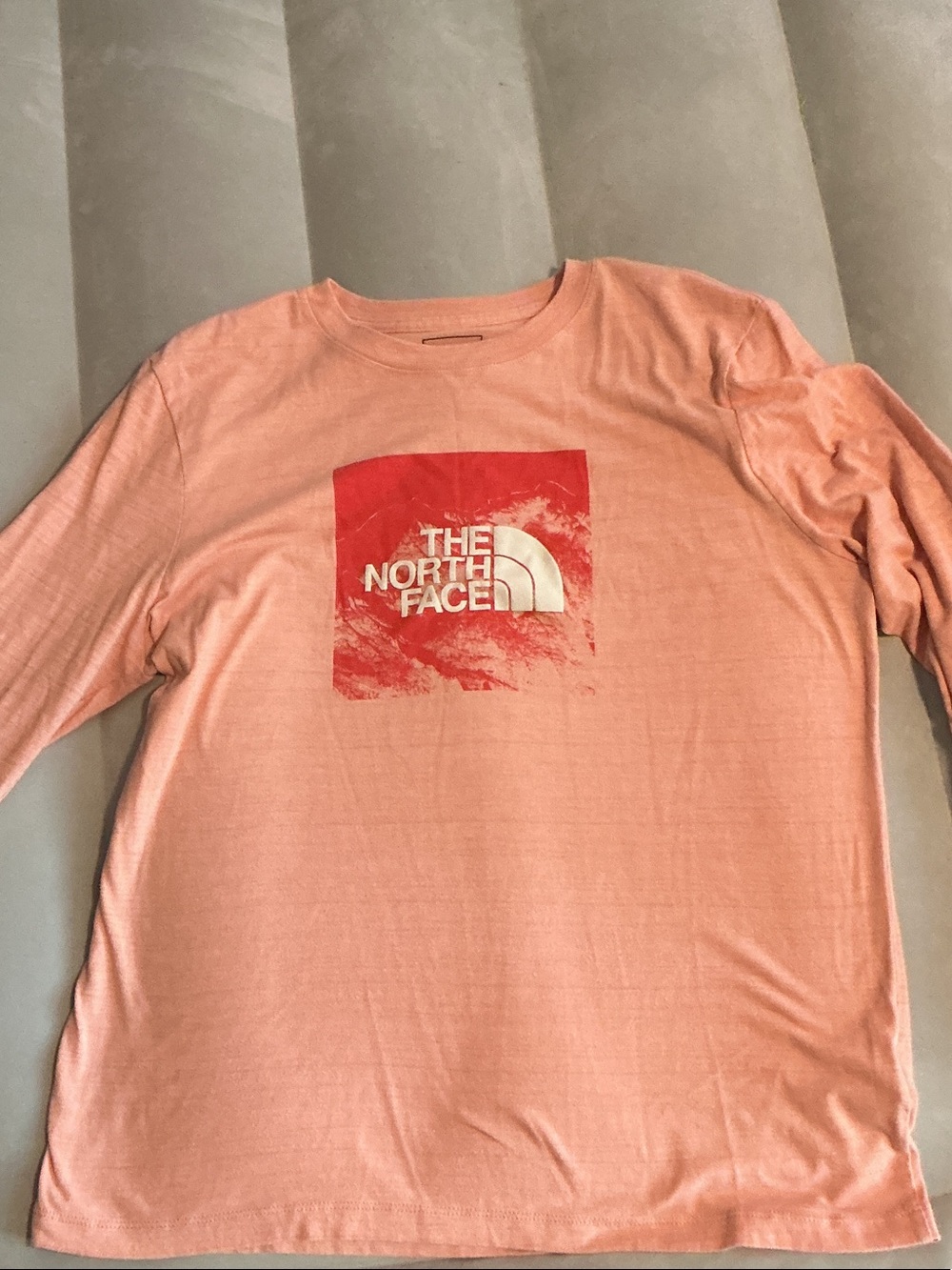 The North Face Women’s Long Sleeve Tee in Peach with Red Logo